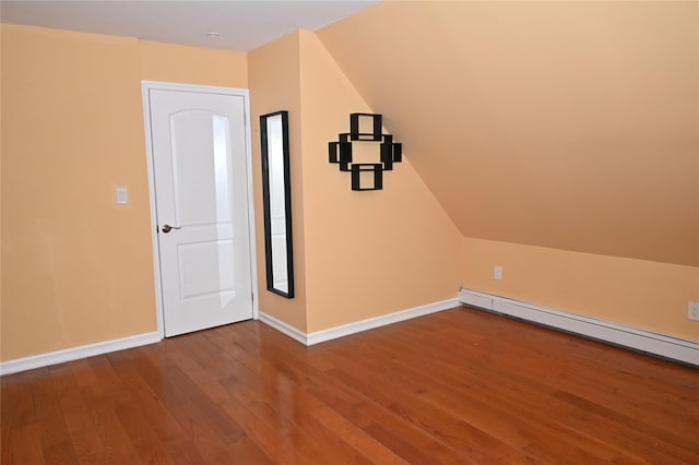 bonus room featuring baseboard heating, baseboards, wood finished floors, and lofted ceiling