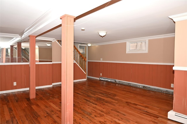 finished basement with stairway, ornamental molding, a baseboard heating unit, and hardwood / wood-style floors