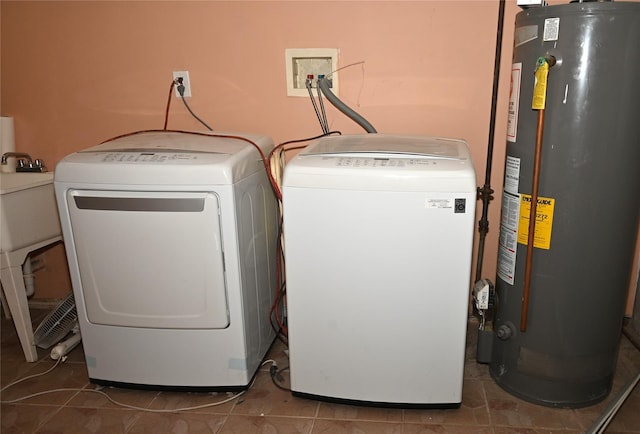 laundry area featuring water heater, laundry area, and washer and clothes dryer