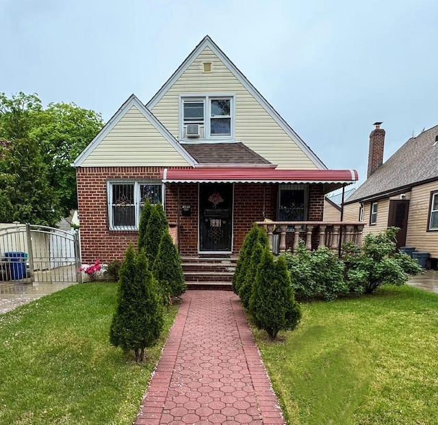 8260 266th St, Glen Oaks, NY 11004 - bungalow with a front yard, brick siding, and cooling unit