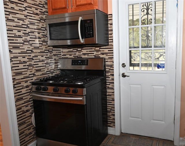 8260 266th St, Glen Oaks, NY 11004 - kitchen with appliances with stainless steel finishes, backsplash, and brown cabinetry