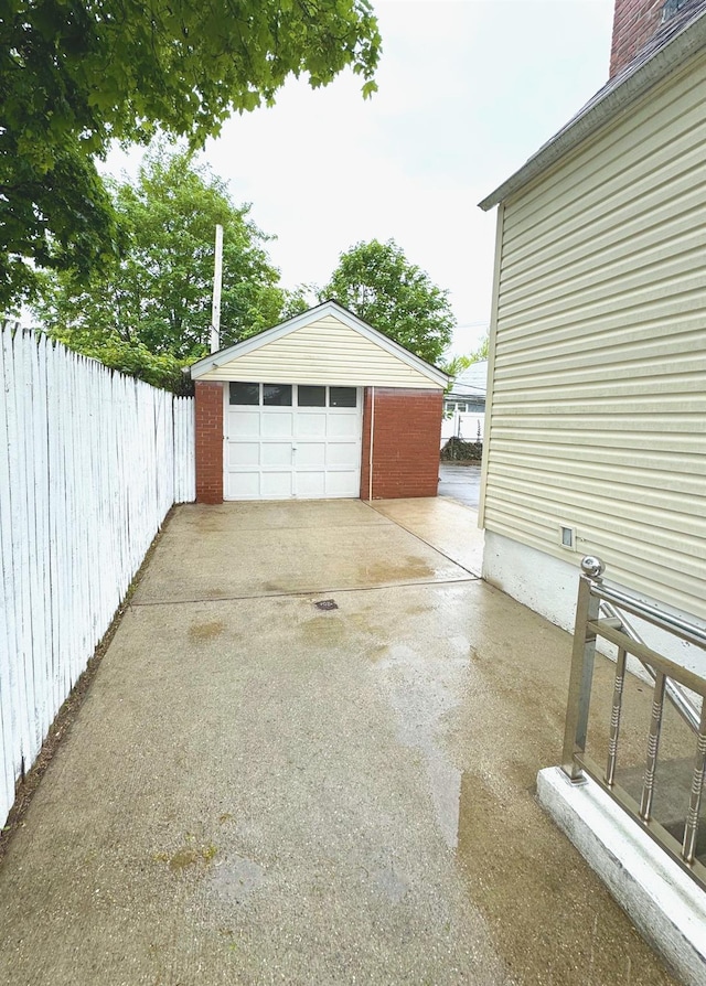 8260 266th St, Glen Oaks, NY 11004 - detached garage featuring fence and concrete driveway