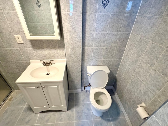 8260 266th St, Glen Oaks, NY 11004 - full bath with vanity, tile walls, toilet, tile patterned flooring, and a stall shower