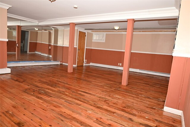 8260 266th St, Glen Oaks, NY 11004 - finished below grade area with hardwood / wood-style floors, a baseboard radiator, ornamental molding, and a wainscoted wall