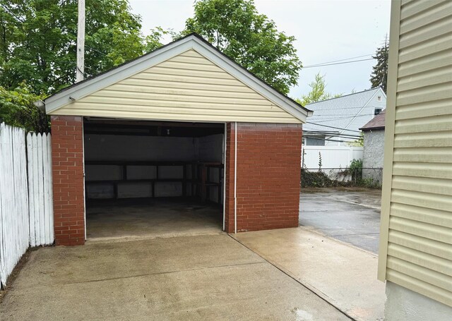 8260 266th St, Glen Oaks, NY 11004 - detached garage featuring fence and concrete driveway