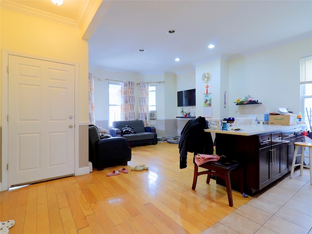 kitchen with crown molding, open floor plan, light wood-style floors, and a wealth of natural light