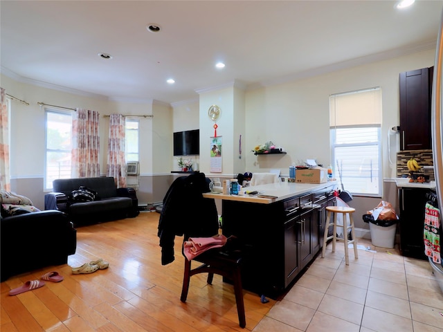kitchen featuring crown molding, light countertops, recessed lighting, and dark cabinets