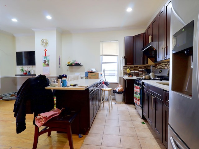 kitchen featuring decorative backsplash, light countertops, freestanding refrigerator, ornamental molding, and gas range oven