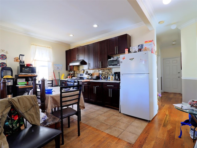 kitchen featuring crown molding, freestanding refrigerator, stove, light countertops, and backsplash