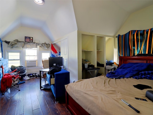 bedroom with cooling unit, dark wood-style flooring, and lofted ceiling