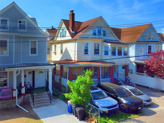 view of front facade with a porch and a chimney
