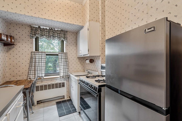 62-15 53rd Ave Unit Lgd, Maspeth, NY 11378 - kitchen with freestanding refrigerator, radiator heating unit, range, wallpapered walls, and white cabinets