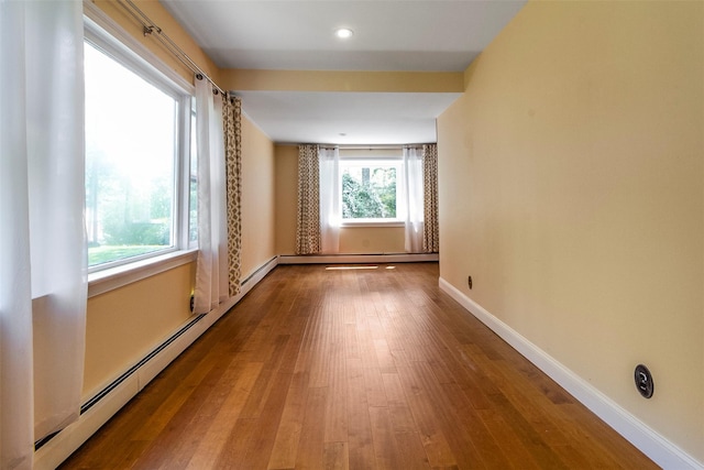 7 Cobblestone Ln, Cortlandt Manor, NY 10567 - empty room featuring wood finished floors, baseboard heating, and recessed lighting