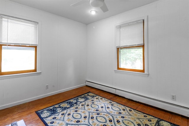 7 Cobblestone Ln, Cortlandt Manor, NY 10567 - empty room with baseboard heating, wood-type flooring, ornamental molding, and ceiling fan