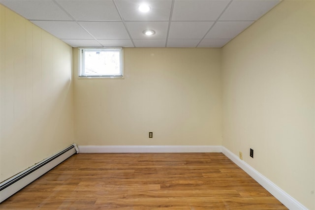 7 Cobblestone Ln, Cortlandt Manor, NY 10567 - unfurnished room with baseboard heating, light wood-style flooring, and a paneled ceiling
