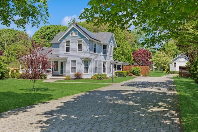 264 Washington Ave, Jamesport, NY 11947 - victorian home featuring a front yard, a shingled roof, and covered porch