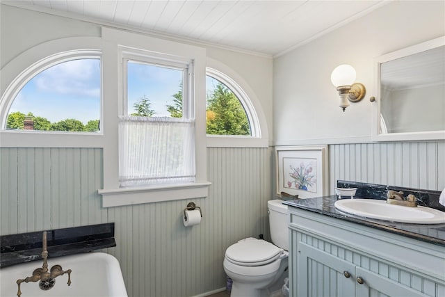 264 Washington Ave, Jamesport, NY 11947 - bathroom with a soaking tub, vanity, crown molding, and wainscoting