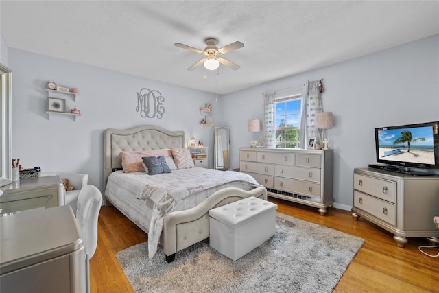 bedroom featuring wood finished floors and a ceiling fan