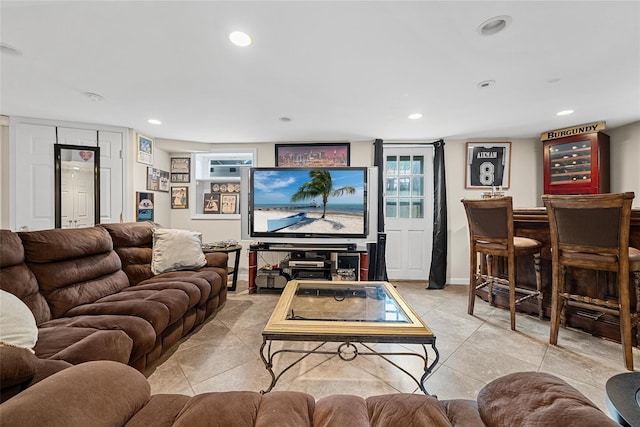 living area featuring a dry bar, light tile patterned floors, and recessed lighting