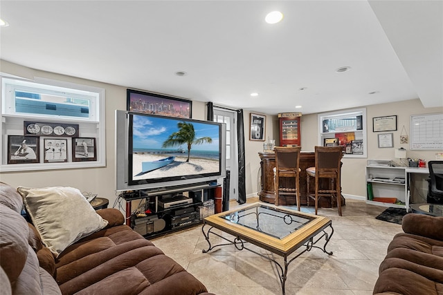 tiled living area featuring a bar, recessed lighting, baseboards, and plenty of natural light
