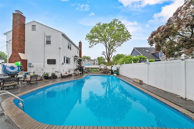 view of swimming pool with a fenced backyard
