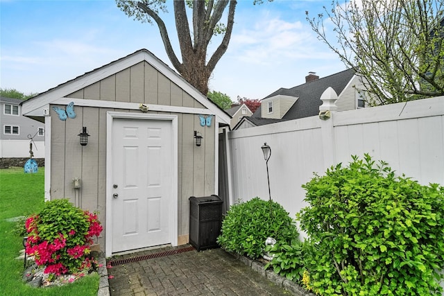view of shed featuring fence