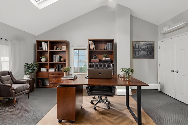 office area with high vaulted ceiling and baseboards
