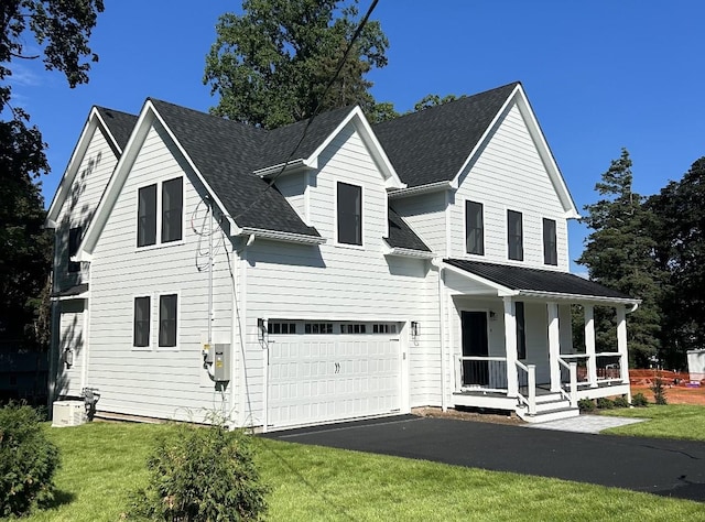 4 Haring Ave, Sparkill, NY 10976 - view of front of property featuring covered porch, a garage, driveway, a front lawn, and roof with shingles
