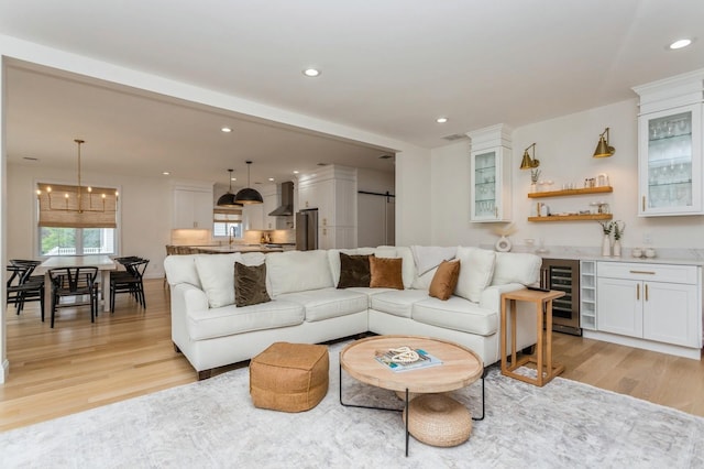 4 Haring Ave, Sparkill, NY 10976 - living room with light wood-style flooring, beverage cooler, wet bar, recessed lighting, and a chandelier