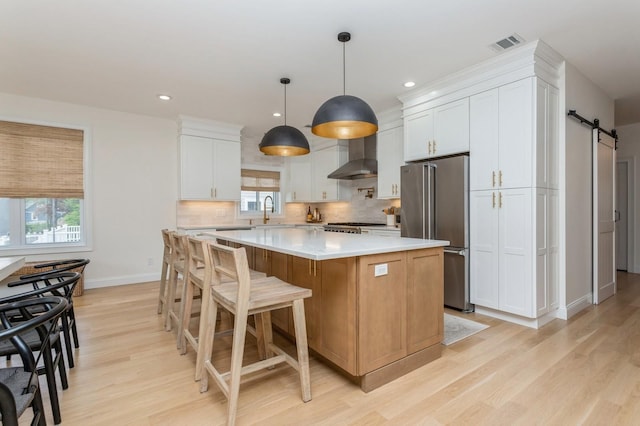 4 Haring Ave, Sparkill, NY 10976 - kitchen featuring freestanding refrigerator, a barn door, a center island, light wood-style flooring, and recessed lighting