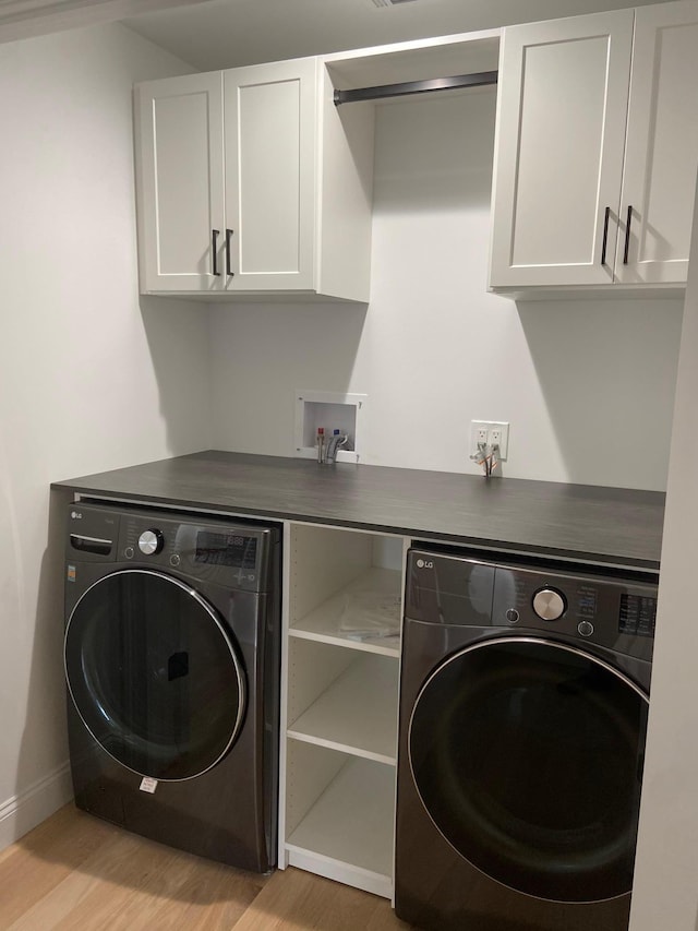 4 Haring Ave, Sparkill, NY 10976 - laundry room featuring cabinet space, light wood-style floors, washing machine and dryer, and baseboards