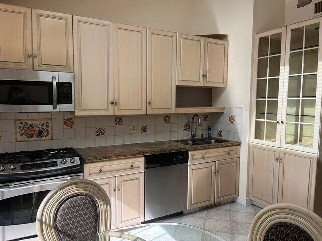 45 Princeton Dr, Tappan, NY 10983 - kitchen featuring appliances with stainless steel finishes, decorative backsplash, dark stone countertops, open shelves, and light tile patterned floors