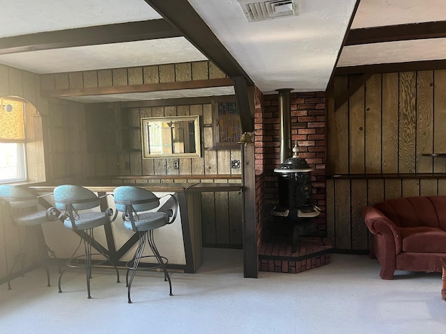 45 Princeton Dr, Tappan, NY 10983 - bar with a wood stove, wooden walls, beamed ceiling, and light floors