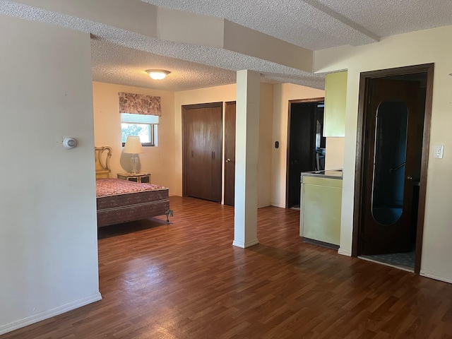 45 Princeton Dr, Tappan, NY 10983 - bedroom featuring dark wood-type flooring, a textured ceiling, washer / dryer, and a closet