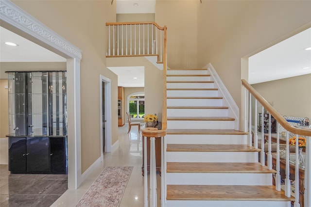 12 Barbera Rd, Commack, NY 11725 - stairs featuring baseboards, tile patterned flooring, a high ceiling, and recessed lighting