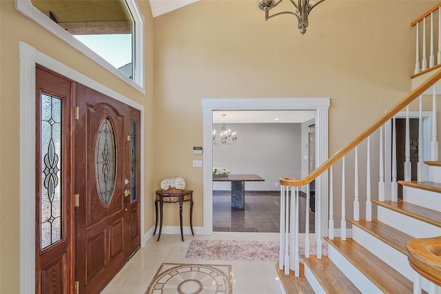 12 Barbera Rd, Commack, NY 11725 - foyer with a chandelier, a towering ceiling, stairs, baseboards, and tile patterned floors