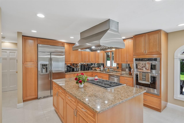 12 Barbera Rd, Commack, NY 11725 - kitchen with appliances with stainless steel finishes, island range hood, light stone counters, a center island, and baseboards