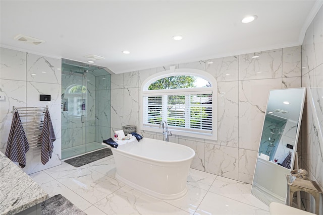 12 Barbera Rd, Commack, NY 11725 - bathroom featuring tile walls, marble tiled flooring, a marble finish shower, crown molding, and a freestanding tub