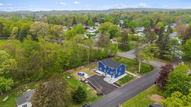 birds eye view of property featuring a wooded view