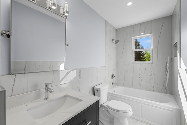 bathroom featuring toilet, a wainscoted wall, shower / washtub combination, tile walls, and vanity