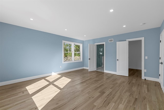 spare room featuring recessed lighting, baseboards, visible vents, and light wood-style floors