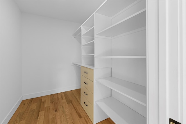 walk in closet featuring light wood finished floors