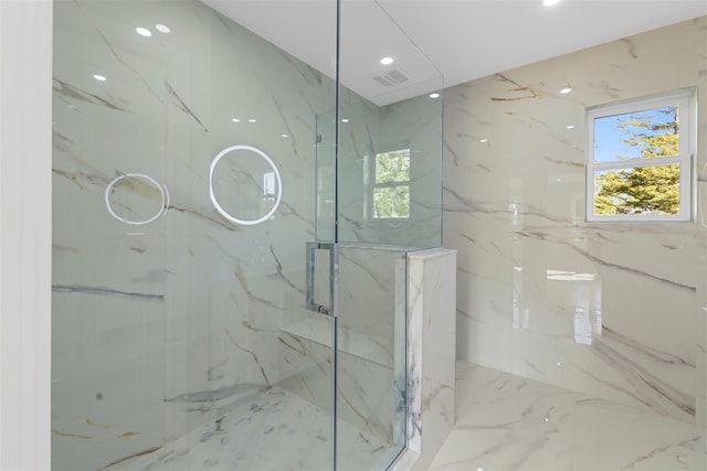 full bath featuring a marble finish shower, visible vents, stone wall, marble finish floor, and recessed lighting
