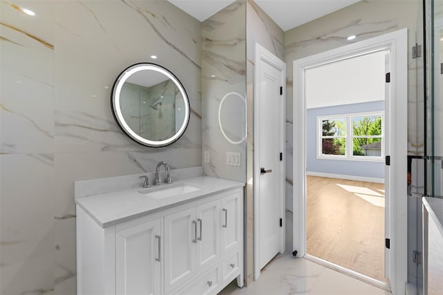 bathroom with marble finish floor and vanity