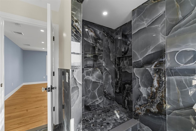 full bathroom featuring recessed lighting, baseboards, walk in shower, visible vents, and wood finished floors