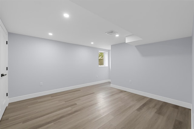 below grade area featuring light wood-type flooring, recessed lighting, baseboards, and visible vents
