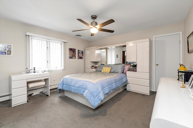 bedroom featuring dark colored carpet, a baseboard heating unit, and a ceiling fan