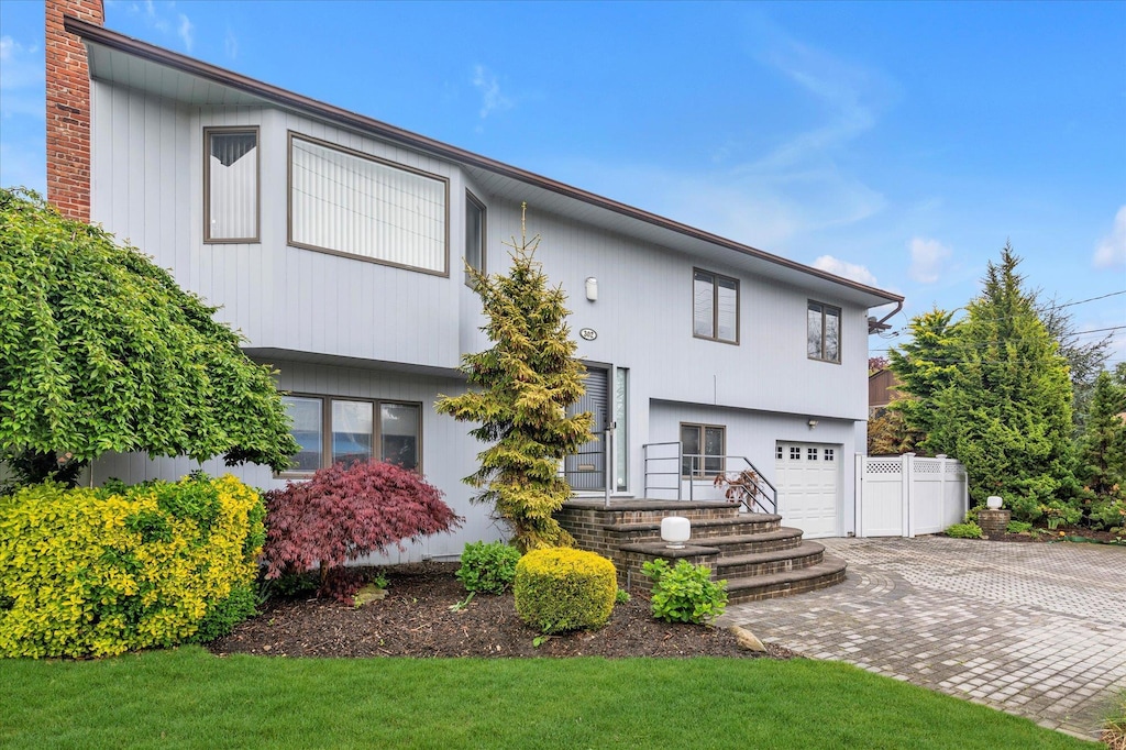 302 Blackheath Rd, Lido Beach, NY 11561 - view of front of property featuring decorative driveway, a chimney, and an attached garage