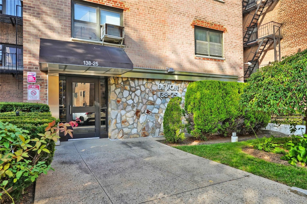 doorway to property with brick siding and stone siding