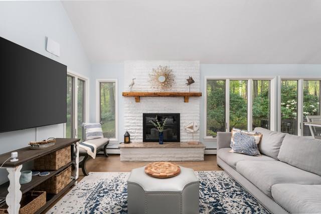 6 Circle Dr, Shoreham, NY 11786 - living area with a baseboard heating unit, a fireplace, wood finished floors, and high vaulted ceiling